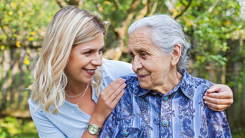 Elderly female with young lady touching shoulder